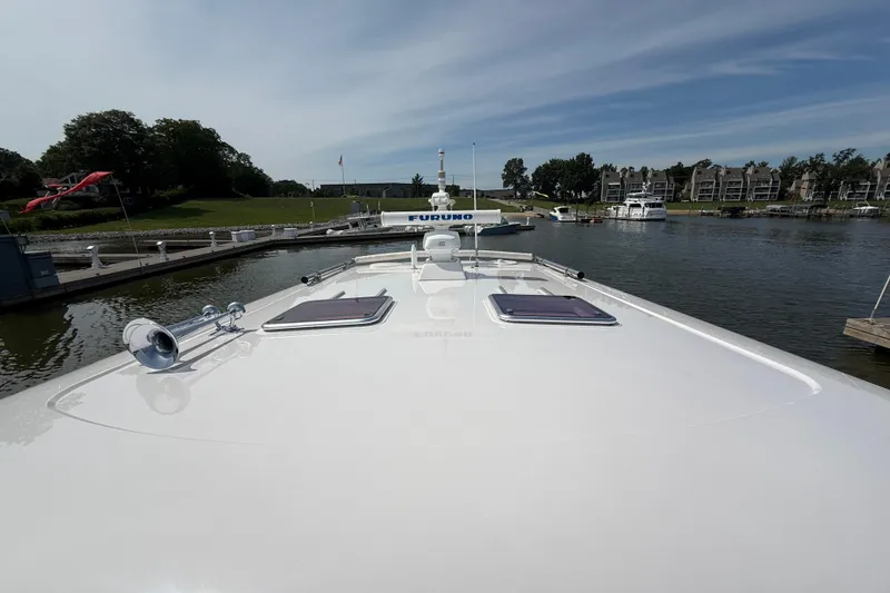 Slide: The Image of 2013 Sabre 42 Salon Express yacht docked at a marina, showcasing sleek design and waterfront view. - 23