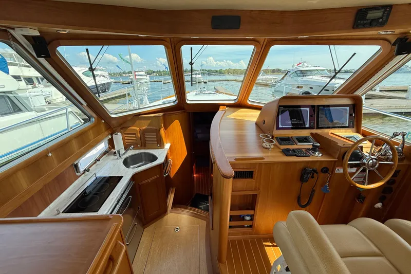 Slide: The Image of Interior of 2013 Sabre 42 Salon Express yacht with helm, kitchen, and marina view. - 40