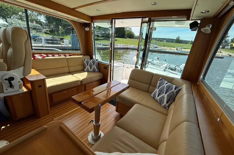 Slide: The Image of Luxurious interior of 2013 Sabre 42 Salon Express yacht with plush seating and scenic marina view. - 34