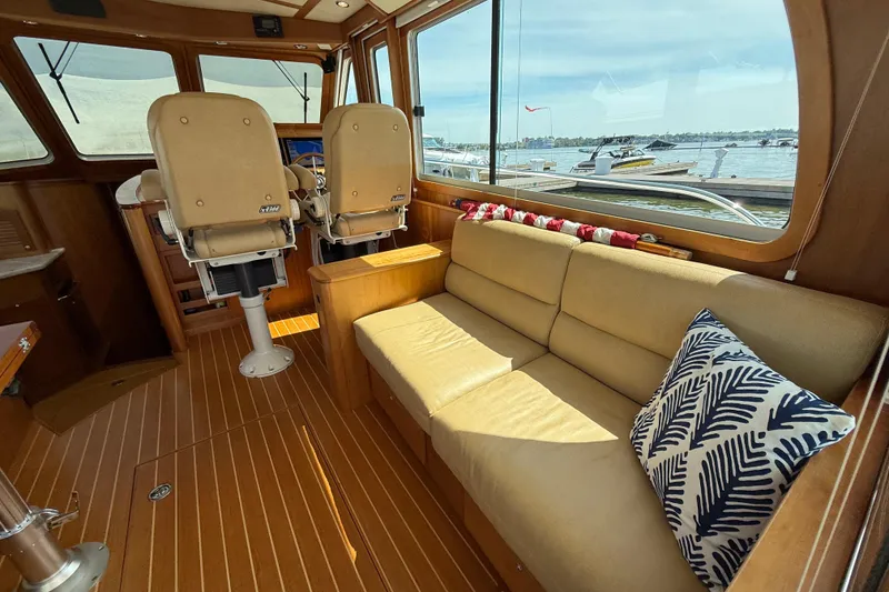 Slide: The Image of Interior of 2013 Sabre 42 Salon Express with beige seating and nautical decor. - 33