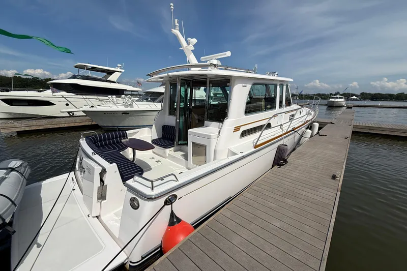 Slide: The Image of 2013 Sabre 42 Salon Express yacht docked at marina under clear sky. - 10