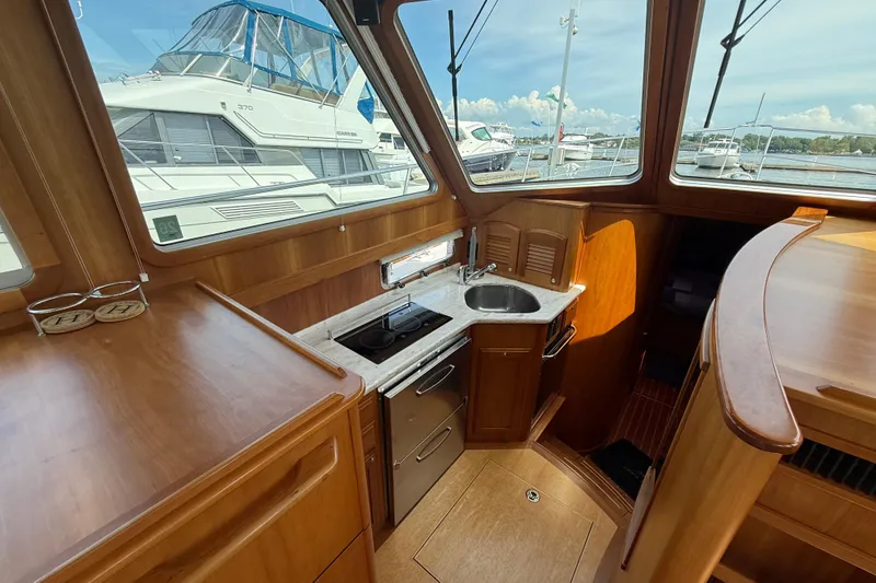 Slide: The Image of Interior of 2013 Sabre 42 Salon Express yacht with wooden cabinetry and compact kitchen. - 51