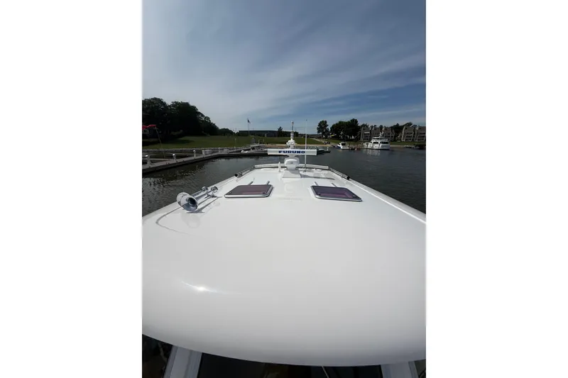 Slide: The Image of 2013 Sabre 42 Salon Express yacht docked at a marina under a clear sky. - 24