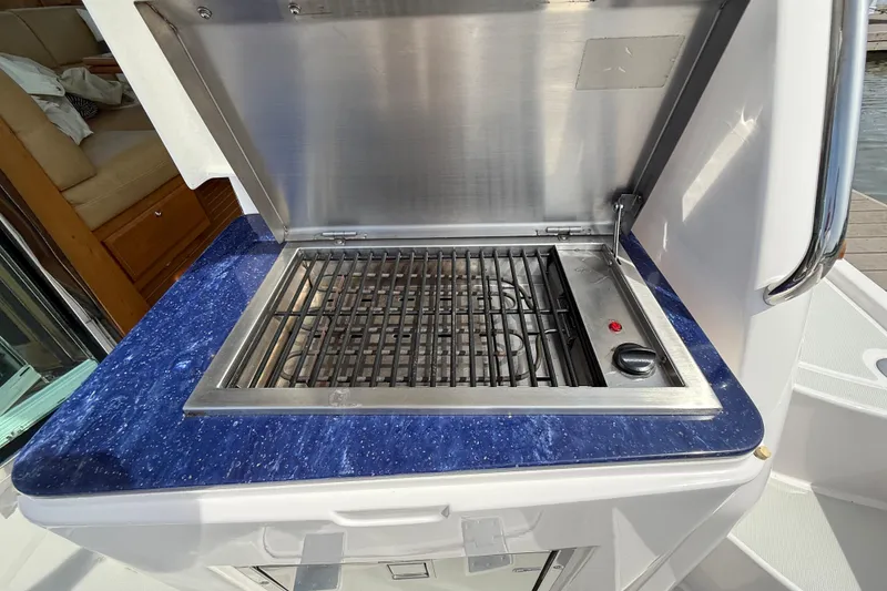 Slide: The Image of Outdoor grill on 2013 Sabre 42 Salon Express yacht with blue countertop. - 19