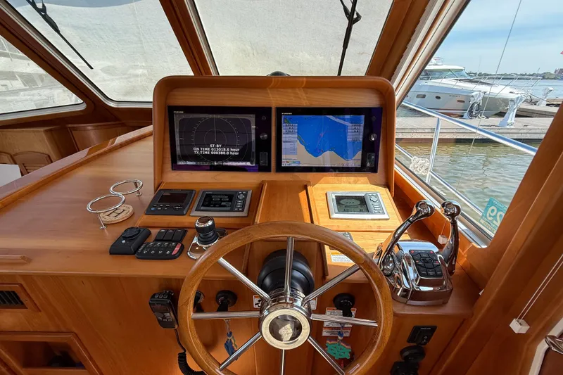 Slide: The Image of Helm of 2013 Sabre 42 Salon Express with navigation screens and controls. - 44