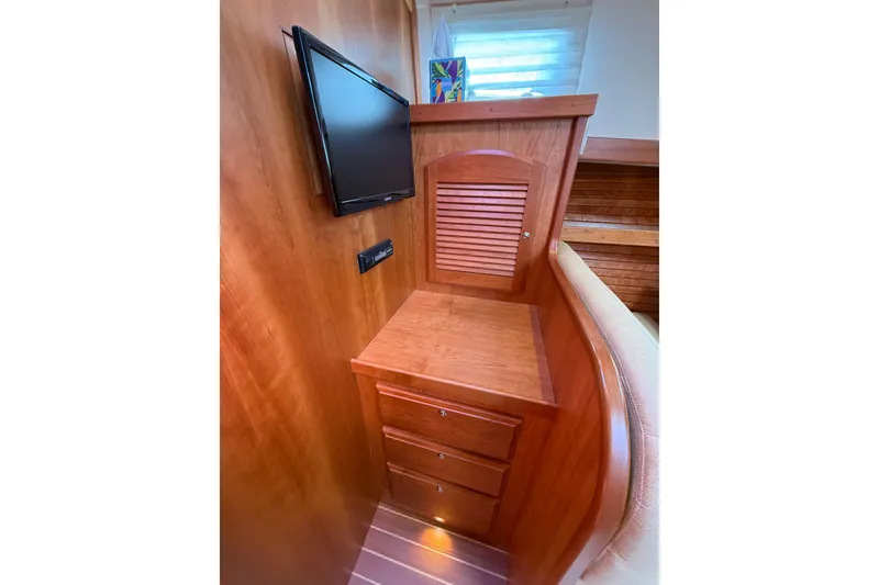 Slide: The Image of 2013 Sabre 42 Salon Express interior with wooden cabinetry and mounted TV. - 67