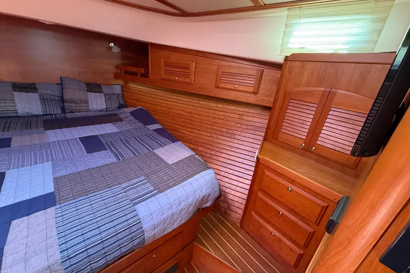 Slide: The Image of Luxurious cabin interior of 2013 Sabre 42 Salon Express with wood finish and cozy bedding. - 63