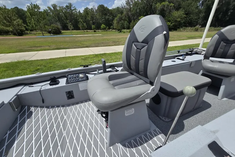 Slide: The Image of 2020 G3 Sportsman 1610 SS boat interior with gray seating and control panel. - 4