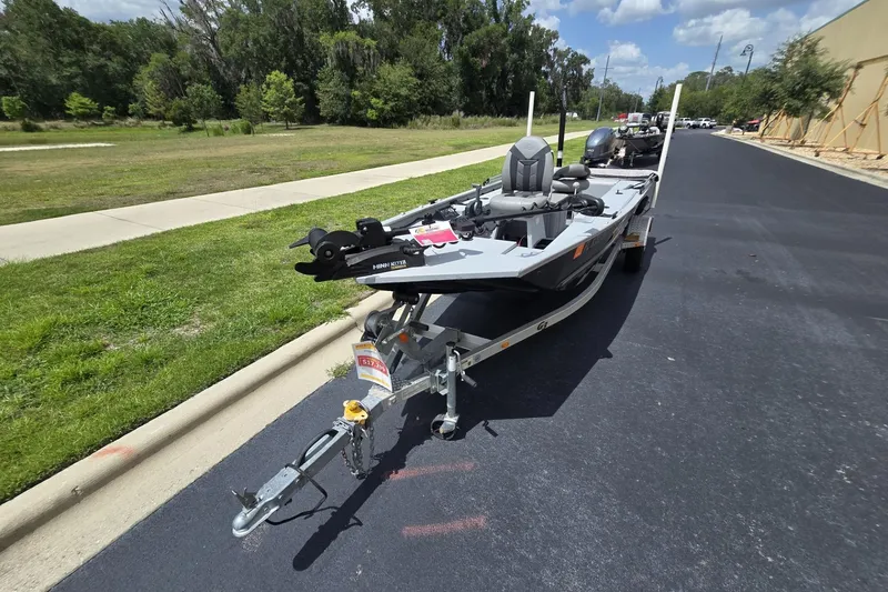 Slide: The Image of 2020 G3 Sportsman 1610 SS boat on trailer, parked on a sunny road. - 9