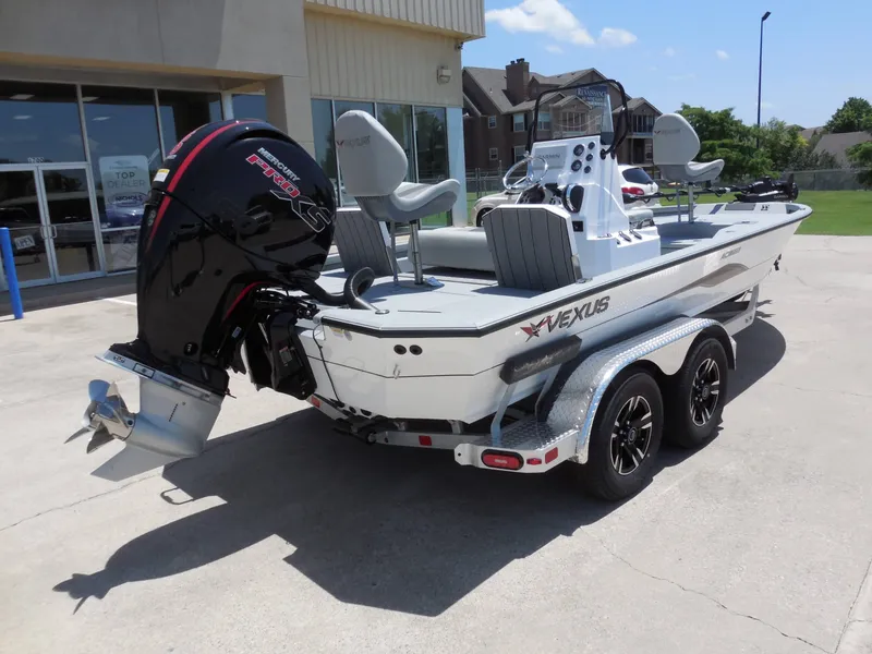 Slide: The Image of A 2026 Vexus ACX2000 boat on a trailer in front of a building. - 3