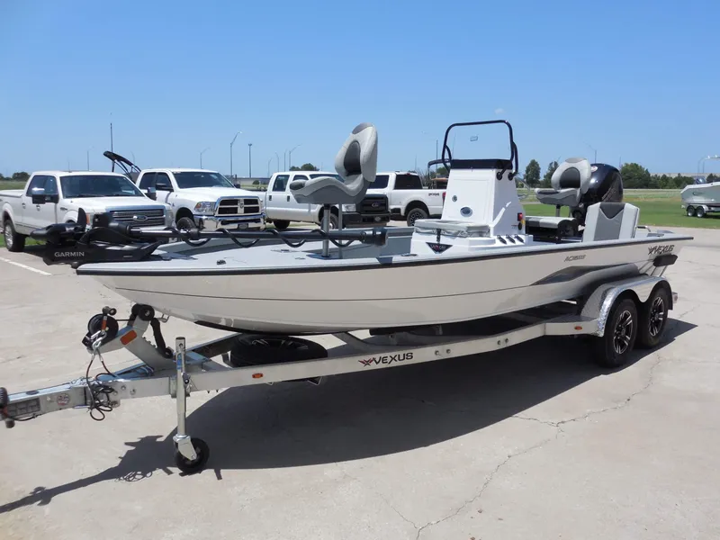Slide: The Image of A 2026 Vexus ACX2000 boat on a trailer in a parking lot. - 7