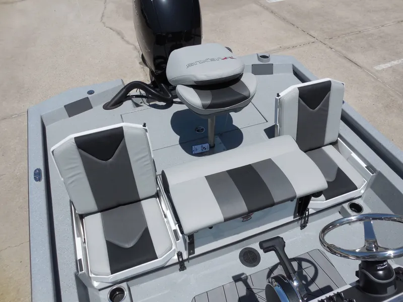 Slide: The Image of The image shows the cockpit of a Vexus ACX2000 boat with gray and black seating. - 13