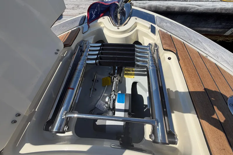 Slide: The Image of View of a 2023 Chris-Craft Launch 28 GT swim ladder, featuring wood accents on the deck. - 17