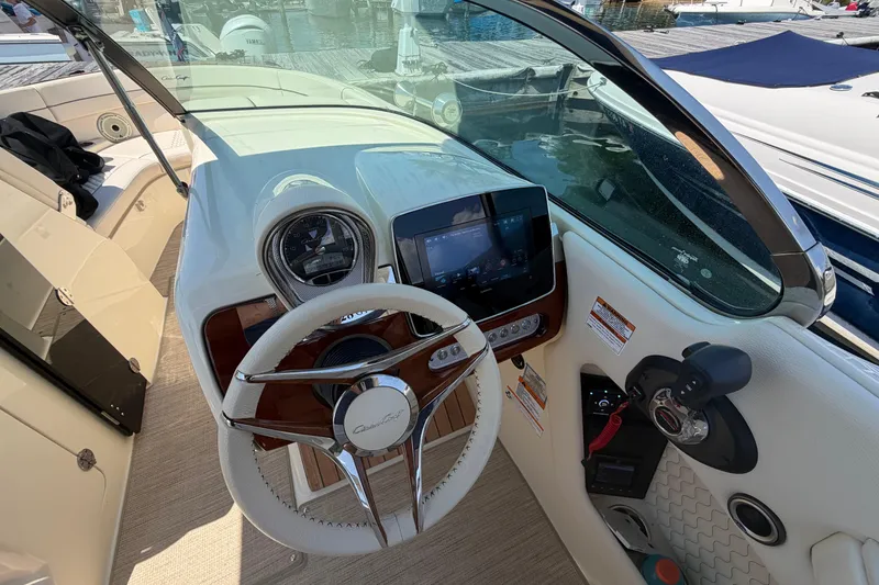 Slide: The Image of 2023 Chris-Craft Launch 28 GT dashboard with steering wheel and navigation display. - 13