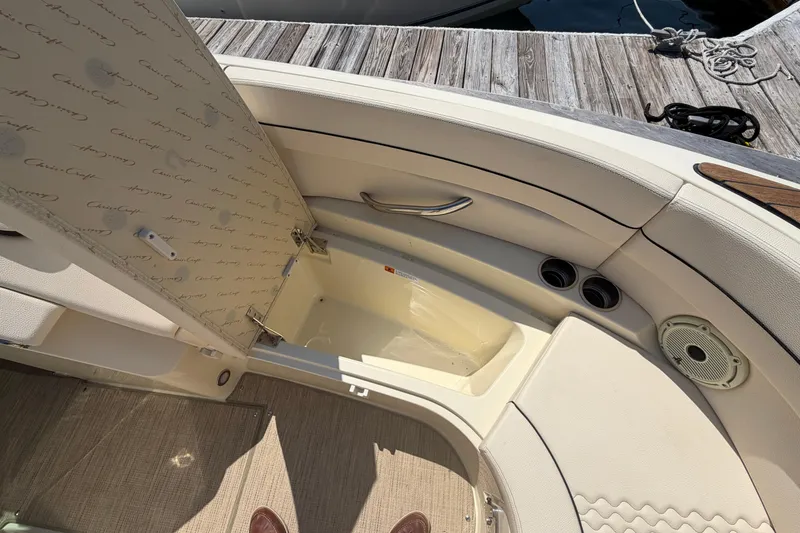 Slide: The Image of The image shows the interior of a 2023 Chris-Craft Launch 28 GT boat with beige upholstery. - 16