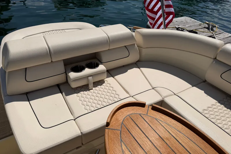 Slide: The Image of Luxurious seating on 2023 Chris-Craft Launch 28 GT boat with elegant wood accents. - 4