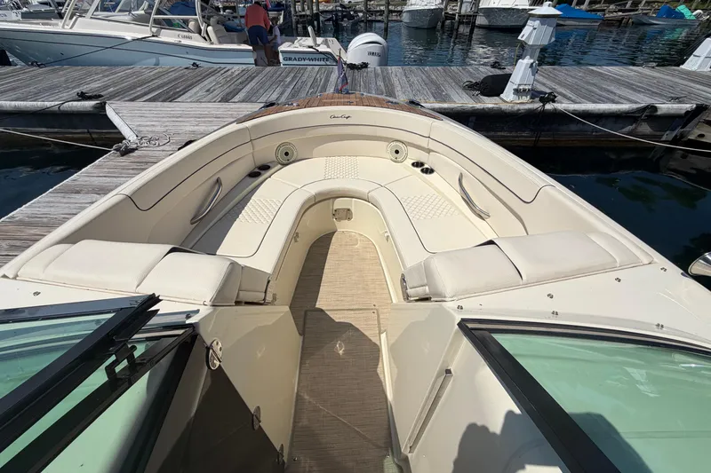 Slide: The Image of 2023 Chris-Craft Launch 28 GT boat interior with luxurious seating at a marina. - 14