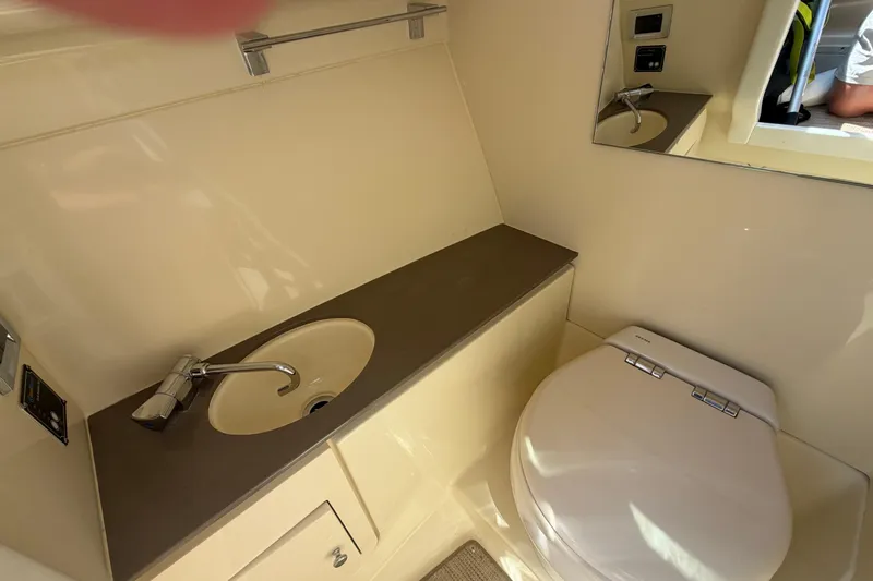 Slide: The Image of 2023 Chris-Craft Launch 28 GT boat bathroom with sink and toilet. - 9