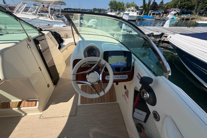 Slide: The Image of 2023 Chris-Craft Launch 28 GT boat cockpit with steering wheel and navigation display. - 7