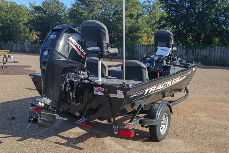 Slide: The Image of 2025 Tracker Pro 170 boat with Mercury engine on trailer, parked outdoors. - 2