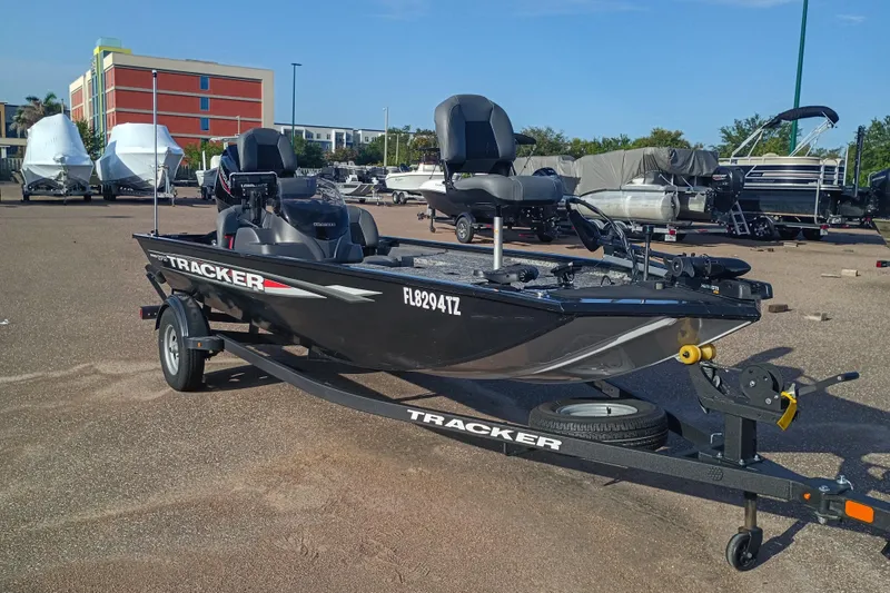 The Image of 2025 Tracker Pro 170 boat on trailer in parking lot, surrounded by other boats. - 0