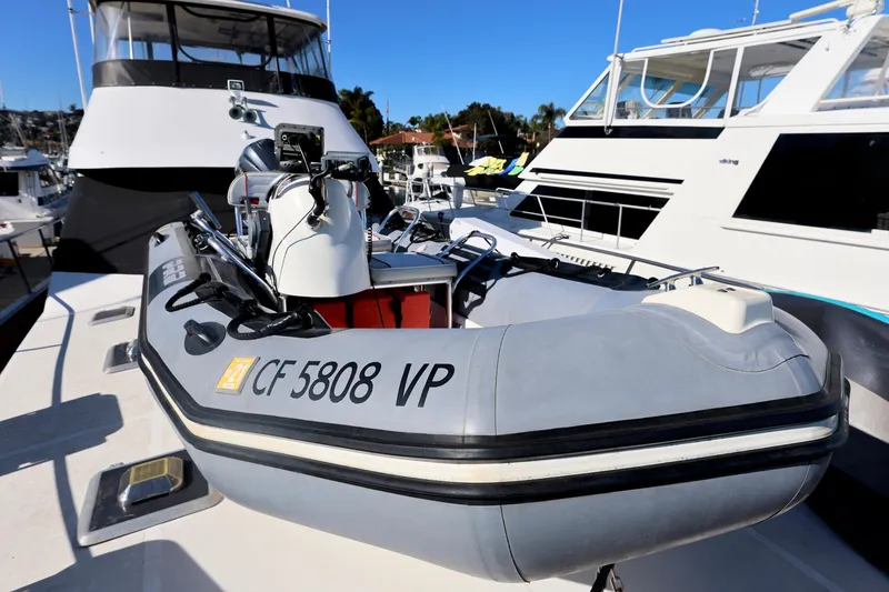 Slide: The Image of Inflatable boat on a 1996 Mediterranean convertible yacht, docked in a marina. - 13
