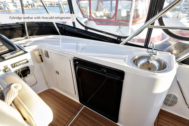 Slide: The Image of 1996 Mediterranean convertible yacht flybridge with wet bar and Norcold refrigerator. - 19