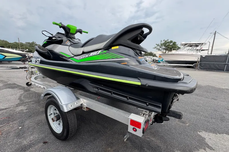 Slide: The Image of 2020 Kawasaki Jetski STX 160LX on trailer, featuring sleek black and green design. - 4