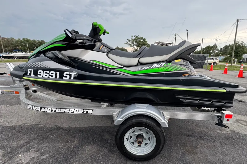 Slide: The Image of A 2020 Kawasaki Jetski STX 160LX on a trailer, featuring green and black accents. - 5