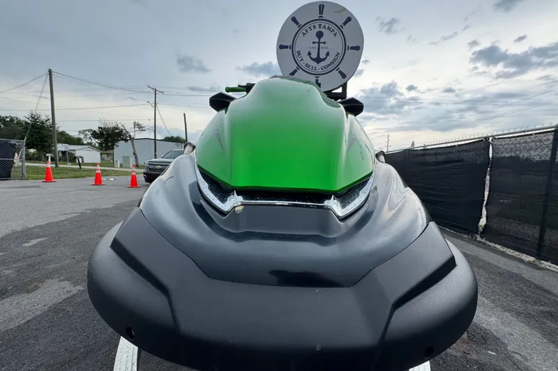 Slide: The Image of 2020 Kawasaki Jetski STX 160LX in vibrant green, parked outdoors on a cloudy day. - 7