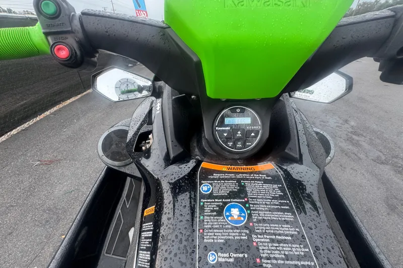 Slide: The Image of 2020 Kawasaki Jetski STX 160LX dashboard with controls and warning labels. - 11