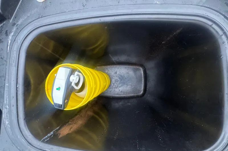 Slide: The Image of A yellow bucket with a device inside is placed in a black compartment. - 12