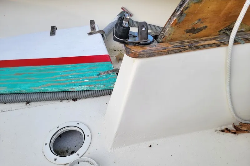 Slide: The Image of Interior view of a 1999 Custom Fiberglass Beetle Cat 12 sailboat, featuring colorful wooden elements. - 23