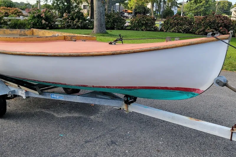 Slide: The Image of Custom Fiberglass Beetle Cat 12 sailboat on trailer, 1999 model, parked outdoors. - 27