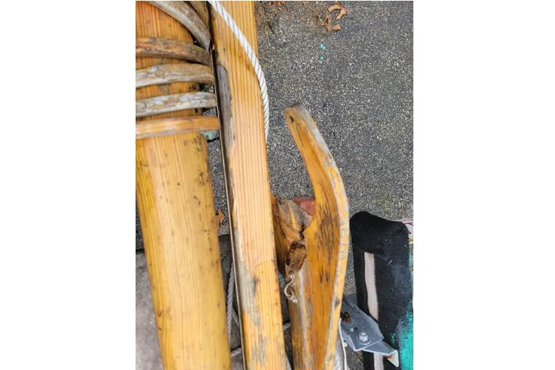 Slide: The Image of Close-up of a 1999 Custom Fiberglass Beetle Cat 12 wooden mast and rigging. - 19