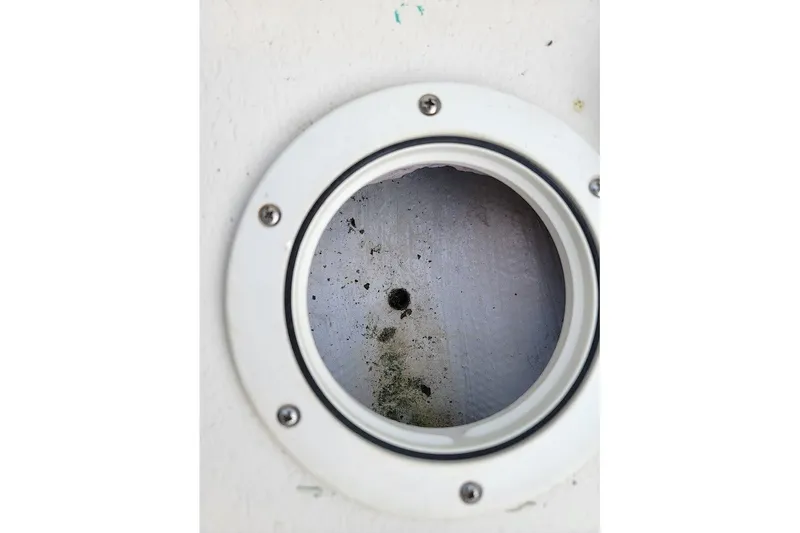 Slide: The Image of Circular opening on a 1999 Custom Fiberglass Beetle Cat 12 boat surface. - 16