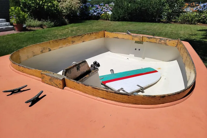 Slide: The Image of Wooden Beetle Cat 14 Classic boat hull, 1999 model, displayed on grass. - 3