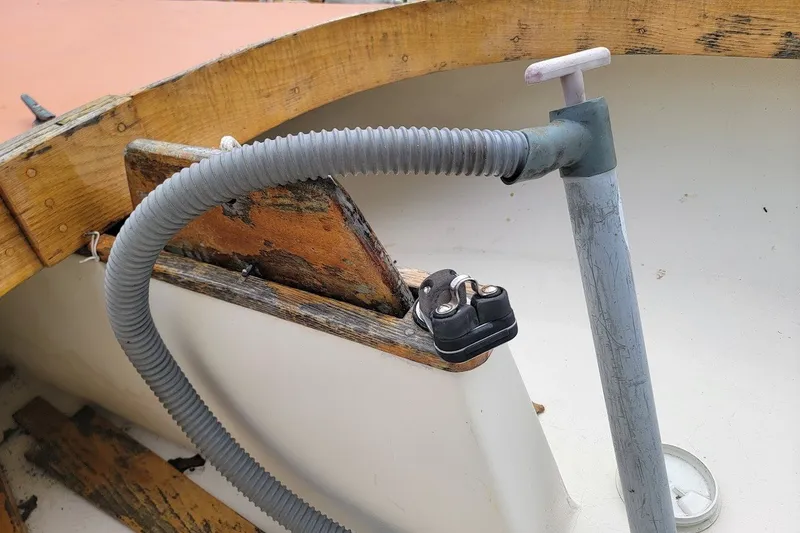 Slide: The Image of Close-up of a 1999 Custom Fiberglass Beetle Cat 12 boat interior with wooden and metal components. - 17