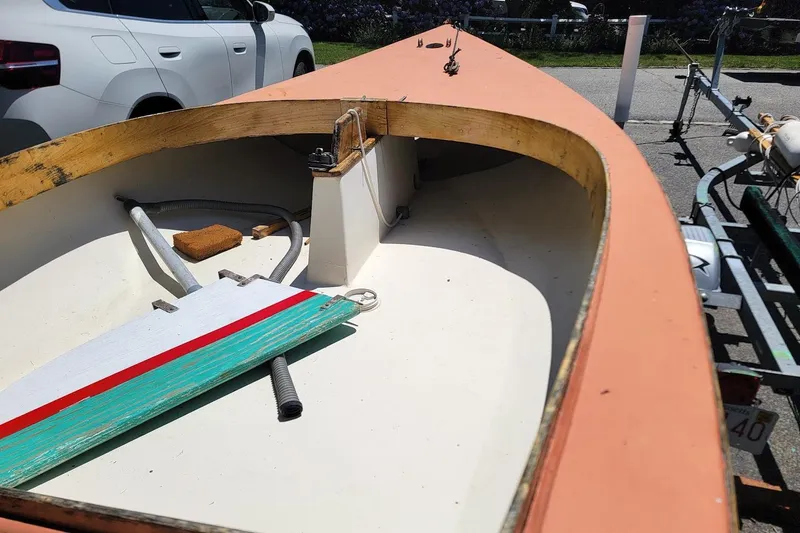 Slide: The Image of 1999 Beetle Cat 14 Classic sailboat interior with wooden trim and colorful rudder. - 4