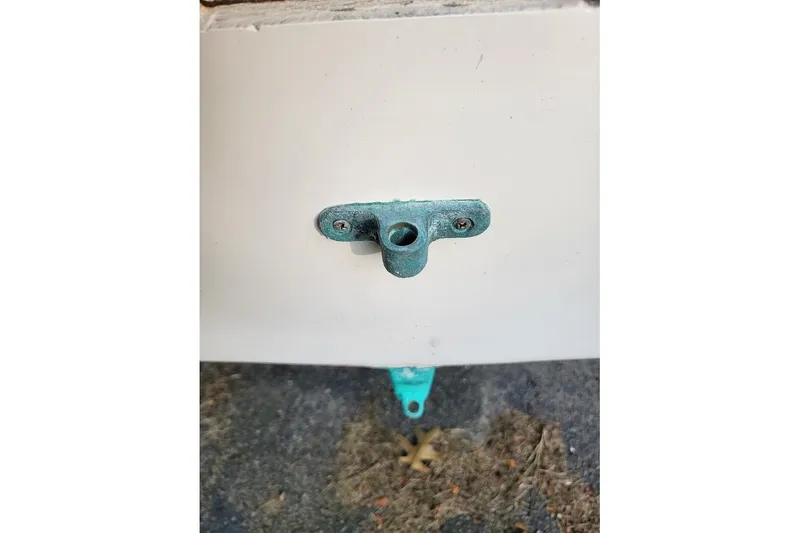 Slide: The Image of Close-up of a 1999 Custom Fiberglass Beetle Cat 12 boat fitting on a white surface. - 26