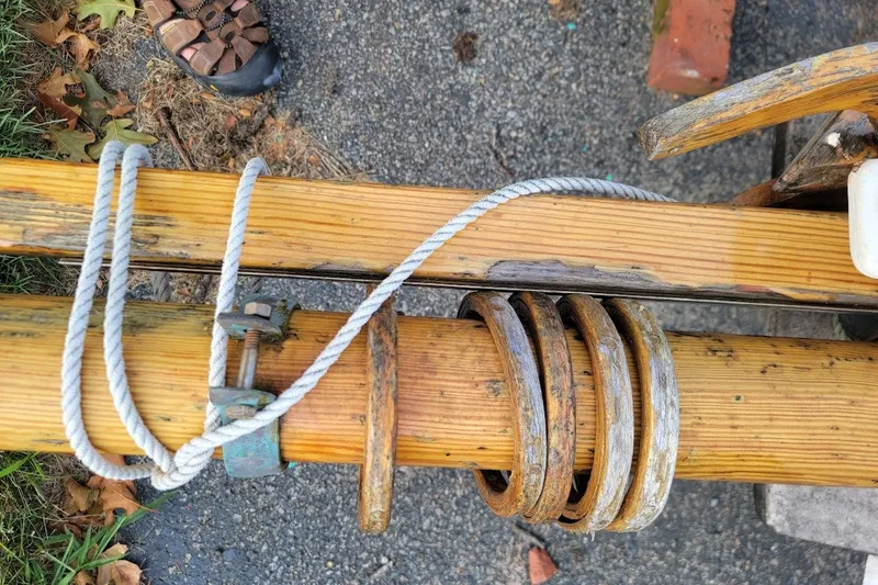 Slide: The Image of Wooden mast with rope and fittings on a 1999 Custom Fiberglass Beetle Cat 12 sailboat. - 20