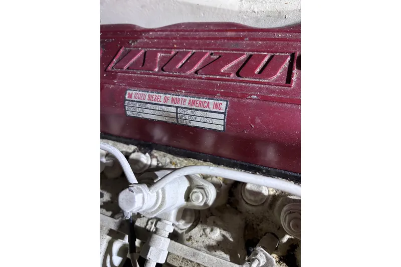 Slide: The Image of Red Isuzu diesel engine in a 1981 Hershine 40 boat, close-up view. - 31
