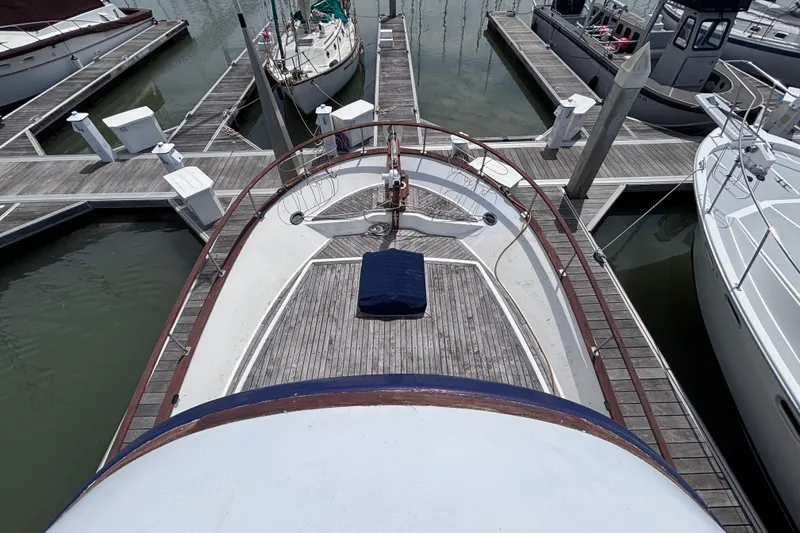 Slide: The Image of 1981 Hershine 40 yacht docked at marina, top view of deck and surrounding boats. - 49