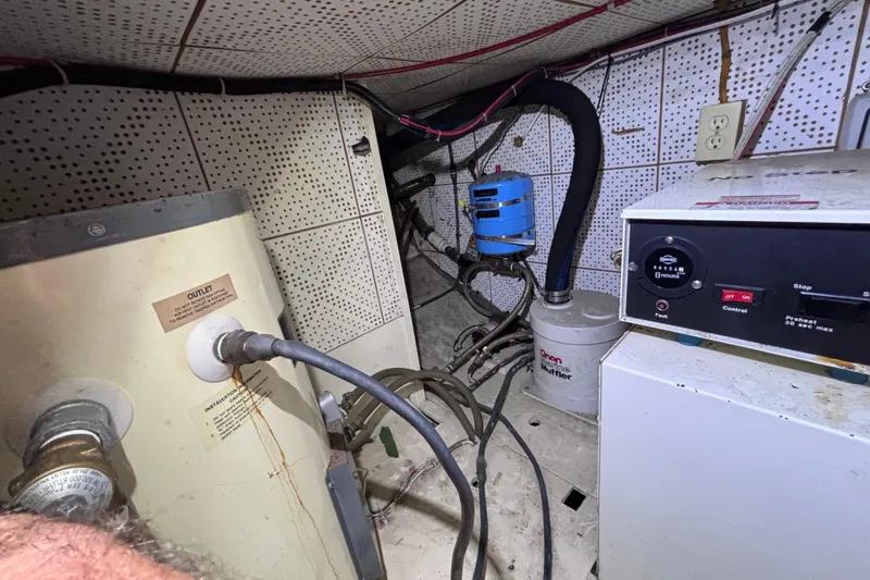 Slide: The Image of Engine room of a 1981 Hershine 40 boat with various equipment and wiring. - 25