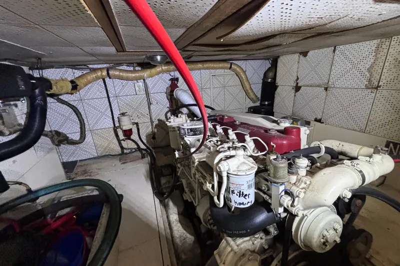 Slide: The Image of Engine room of a 1981 Hershine 40 boat, showcasing mechanical components and piping. - 23
