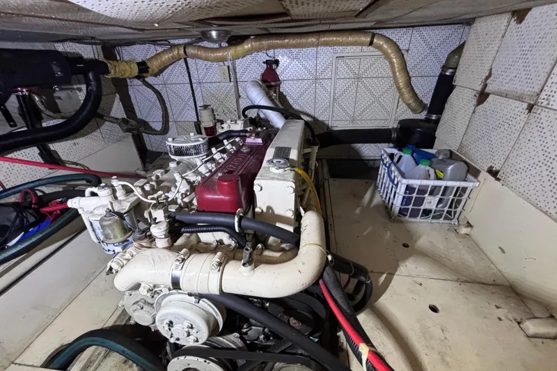 Slide: The Image of Engine room of a 1981 Hershine 40 boat with visible machinery and storage basket. - 22
