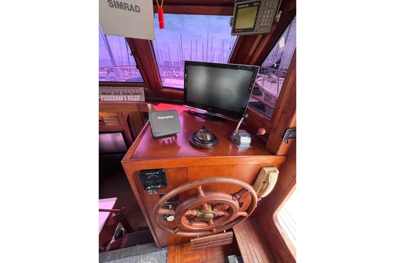 Slide: The Image of Interior helm of 1981 Hershine 40 boat with navigation equipment and wooden steering wheel. - 17