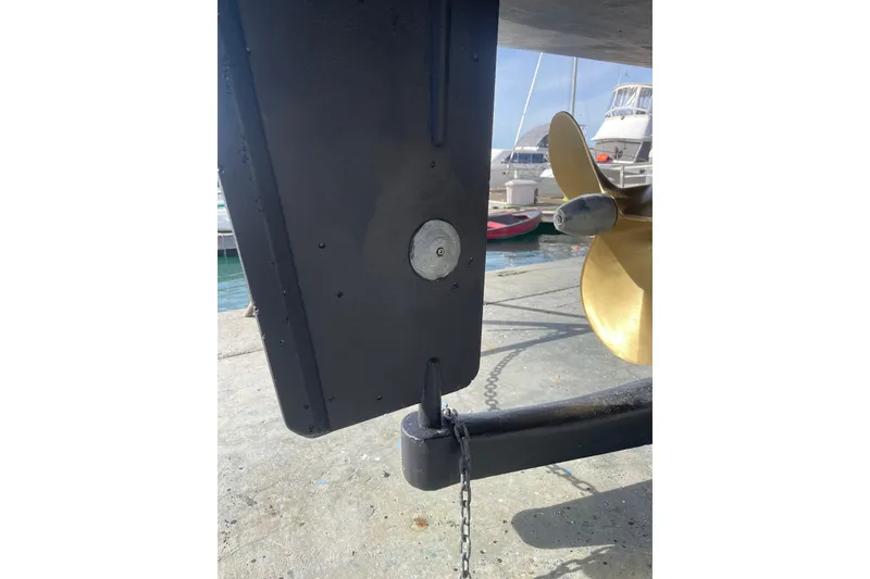 Slide: The Image of Close-up of a 1981 Hershine 40 boat propeller and rudder at a marina. - 34