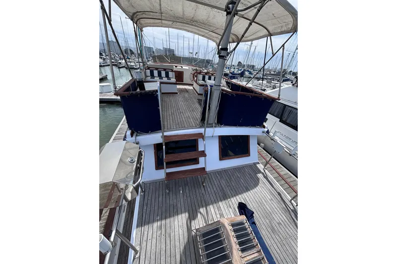Slide: The Image of 1981 Hershine 40 yacht with wooden deck and canopy in marina. - 45