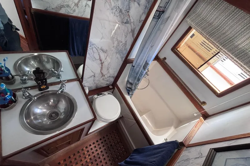 Slide: The Image of Bathroom interior of a 1981 Hershine 40 yacht with sink, toilet, and shower. - 16